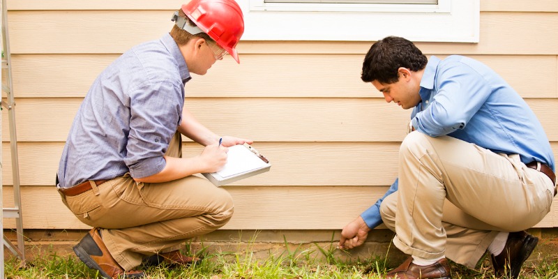 Two inspectors examining a home